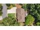 Birds eye view of the home showing the manicured lawn, mature trees, and the roofline at 10530 Tuxford Dr, Alpharetta, GA 30022