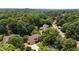 A wide shot of the home shows the lush landscaping and mature trees surrounding the property at 10530 Tuxford Dr, Alpharetta, GA 30022
