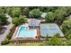 Aerial view shows a pool, tennis courts, clubhouse and parking area for community members at 10530 Tuxford Dr, Alpharetta, GA 30022