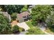 An elevated view of the home and yard shows the mature trees surrounding the house and manicured lawn at 10530 Tuxford Dr, Alpharetta, GA 30022