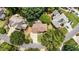 Aerial view of a well maintained suburban home with a long driveway, manicured lawn and mature trees at 10530 Tuxford Dr, Alpharetta, GA 30022