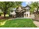Expansive backyard features a deck, patio, stone accents, and mature trees at 10530 Tuxford Dr, Alpharetta, GA 30022