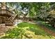 Picturesque backyard with lush green lawn and landscaped terraces, featuring a wood deck at 10530 Tuxford Dr, Alpharetta, GA 30022
