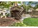 Spacious backyard with lush lawn, stone accents, patio, and deck with stairs at 10530 Tuxford Dr, Alpharetta, GA 30022