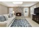 Inviting basement featuring a cozy fireplace, modern television, and ample natural light at 10530 Tuxford Dr, Alpharetta, GA 30022
