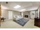 Finished basement area showcasing a brick fireplace, plush carpeting, and ample natural light at 10530 Tuxford Dr, Alpharetta, GA 30022