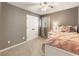 Bright bedroom featuring a neutral color scheme, closet, ceiling fan, and a window that lets in natural light at 10530 Tuxford Dr, Alpharetta, GA 30022