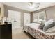 Bedroom with two closets, a ceiling fan, and a window that lets in natural light at 10530 Tuxford Dr, Alpharetta, GA 30022