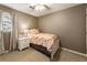 Cozy bedroom features a neutral color scheme, ceiling fan, and a window that allows natural light to illuminate the space at 10530 Tuxford Dr, Alpharetta, GA 30022