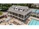 A view of the community clubhouse and pool area with lounge chairs and tennis courts nearby at 10530 Tuxford Dr, Alpharetta, GA 30022