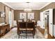 Cozy dining room with hardwood floors, stylish light fixture, and elegant artwork creating a warm ambiance at 10530 Tuxford Dr, Alpharetta, GA 30022