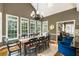 Sunlit dining area featuring many windows, a wooden table, and seating for ten at 10530 Tuxford Dr, Alpharetta, GA 30022