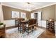 Elegant dining room featuring hardwood floors, a stylish chandelier, and beautiful wall decor at 10530 Tuxford Dr, Alpharetta, GA 30022