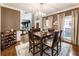 Bright dining room with hardwood floors, natural light, and an open view to the entryway at 10530 Tuxford Dr, Alpharetta, GA 30022