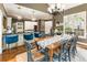 Open-concept dining room with kitchen view, bright light and seating for ten at 10530 Tuxford Dr, Alpharetta, GA 30022