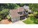 Charming two-story home with a well-manicured lawn, covered front porch and an attached two-car garage at 10530 Tuxford Dr, Alpharetta, GA 30022