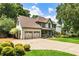 Well-maintained home with manicured lawn, lush landscaping, inviting porch, and two-car garage at 10530 Tuxford Dr, Alpharetta, GA 30022
