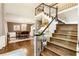 Grand foyer with hardwood floors, staircase, and dining area, creating a welcoming entrance at 10530 Tuxford Dr, Alpharetta, GA 30022