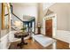 Welcoming foyer features a staircase, hardwood floors, and an ornate mirror, adding a touch of elegance at 10530 Tuxford Dr, Alpharetta, GA 30022