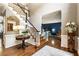 Grand foyer with staircase, hardwood floors, and view into the formal living room, creating an inviting entrance at 10530 Tuxford Dr, Alpharetta, GA 30022