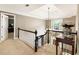 Upstairs hallway with natural light, neutral carpet, and a view of the lower level at 10530 Tuxford Dr, Alpharetta, GA 30022
