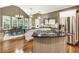 Bright kitchen with stainless steel appliances, granite countertops, and large central island with cooktop at 10530 Tuxford Dr, Alpharetta, GA 30022