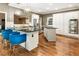Modern kitchen with granite countertops, stainless steel appliances, gas cooktop, and beautiful wood floors at 10530 Tuxford Dr, Alpharetta, GA 30022