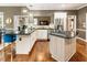 Updated kitchen features stainless steel appliances, granite countertops, and a gas cooktop on the island at 10530 Tuxford Dr, Alpharetta, GA 30022