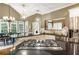 Well-lit kitchen with stainless steel appliances, granite countertops, island cooktop, and adjacent dining area at 10530 Tuxford Dr, Alpharetta, GA 30022