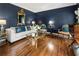 Sophisticated living room with navy blue walls, hardwood floors, and elegant furnishings perfect for entertaining at 10530 Tuxford Dr, Alpharetta, GA 30022