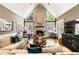 Bright living room featuring a fireplace, large windows, and hardwood floors at 10530 Tuxford Dr, Alpharetta, GA 30022