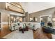 Bright living room with high ceilings, wood floors, and an open layout to the kitchen at 10530 Tuxford Dr, Alpharetta, GA 30022