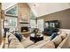 Charming living room with a brick fireplace, large windows, and comfortable furnishings at 10530 Tuxford Dr, Alpharetta, GA 30022