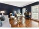 Elegant living room with dark blue walls, hardwood floors, and natural light creating a comfortable atmosphere at 10530 Tuxford Dr, Alpharetta, GA 30022