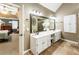 Bathroom featuring double sinks and a tile floor with a jacuzzi visible through an open doorway at 10530 Tuxford Dr, Alpharetta, GA 30022