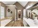 Bright bathroom with double sinks, jacuzzi tub, and walk in closet at 10530 Tuxford Dr, Alpharetta, GA 30022
