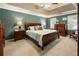 Spacious main bedroom with a coffered ceiling, two windows, and elegant furnishings at 10530 Tuxford Dr, Alpharetta, GA 30022
