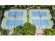 Overhead shot of two well-maintained community tennis courts with professional netting and equipment at 10530 Tuxford Dr, Alpharetta, GA 30022