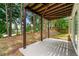 Covered back patio perfect for outdoor seating with shade, surrounded by mature trees at 2169 Wingfoot Pl, Decatur, GA 30035