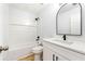 Bathroom featuring white fixtures, black hardware, and a shower-tub combo at 2169 Wingfoot Pl, Decatur, GA 30035