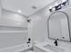 Bathroom featuring a white tub/shower, vanity with a large mirror, and modern lighting fixtures at 2169 Wingfoot Pl, Decatur, GA 30035