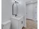 Bathroom featuring modern vanity with mirror, black hardware, and wood-look flooring at 2169 Wingfoot Pl, Decatur, GA 30035