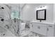 Modern bathroom boasts a glass shower, soaking tub, and white vanity with marble accents throughout the space at 2169 Wingfoot Pl, Decatur, GA 30035