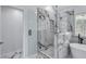 Bright bathroom features a shower and separate tub, marble tile, and natural light at 2169 Wingfoot Pl, Decatur, GA 30035
