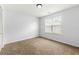 Bedroom with neutral carpet, light walls, and a single window at 2169 Wingfoot Pl, Decatur, GA 30035