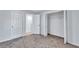 Bright bedroom with plush carpet, closet space, and ample natural light from the open door at 2169 Wingfoot Pl, Decatur, GA 30035