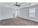 Primary bedroom featuring tray ceilings, plush carpet, and access to the bathroom at 2169 Wingfoot Pl, Decatur, GA 30035