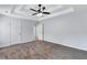 Spacious bedroom features neutral walls, plush carpet, tray ceilings, and access to the bathroom at 2169 Wingfoot Pl, Decatur, GA 30035