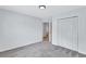 Bedroom featuring neutral carpeting and a double door closet for ample storage at 2169 Wingfoot Pl, Decatur, GA 30035