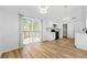 Bright dining room features a sliding door to a deck, modern lighting, and an open layout to the kitchen at 2169 Wingfoot Pl, Decatur, GA 30035